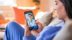 A woman using a healthcare app on her smartphone